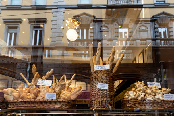 artisanal bread display in a shop window reflecting the city