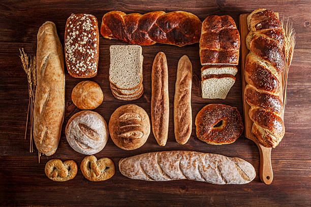 Assortment of artisan breads on rustic wooden table