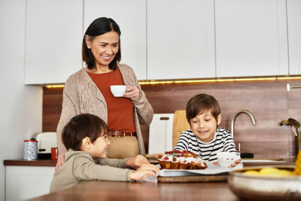joyful asian family enjoying cooking together